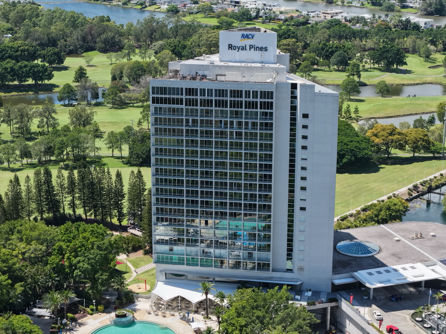 Close aerial view of RACV Royal Pines Resort showing the tinted high-rise glazing.