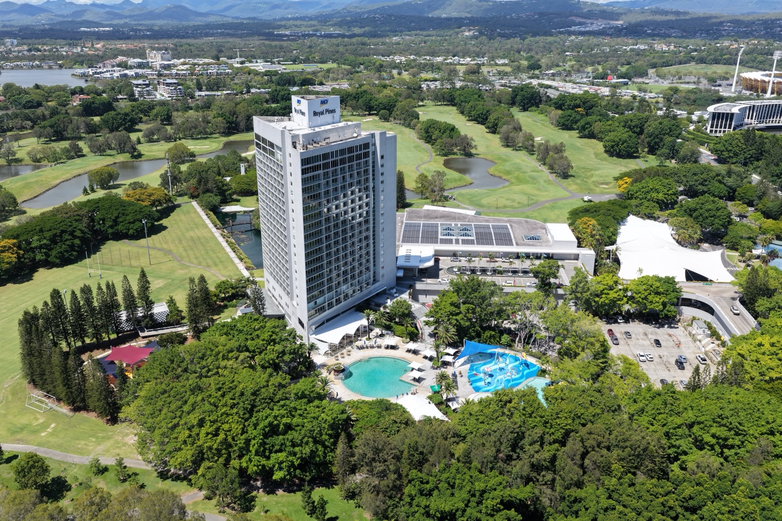Aerial view of RACV Royal Pines Resort showing the high-rise tower and resort grounds.