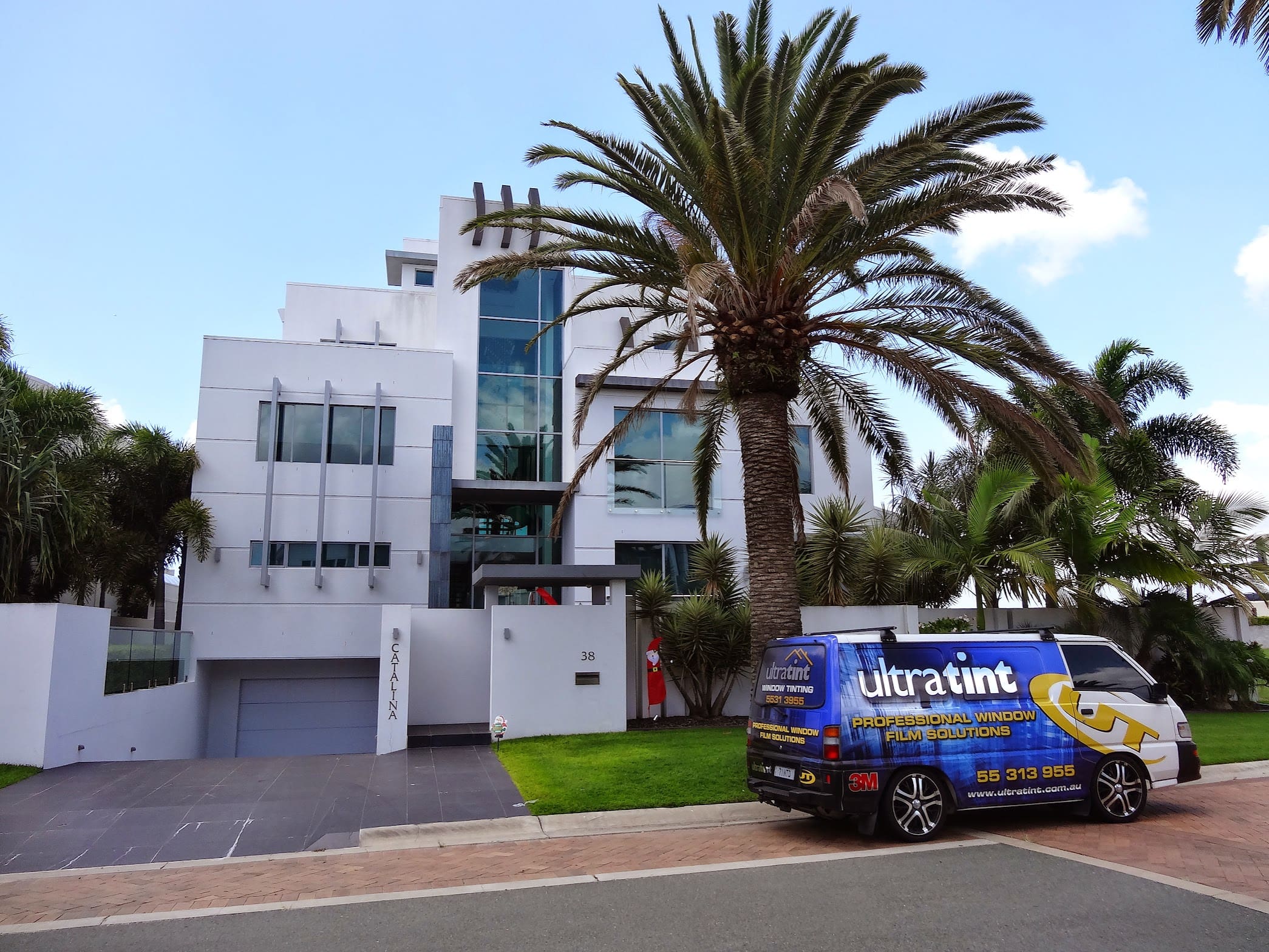 Ultra Tint vehicle parked beside a residential tinting project.